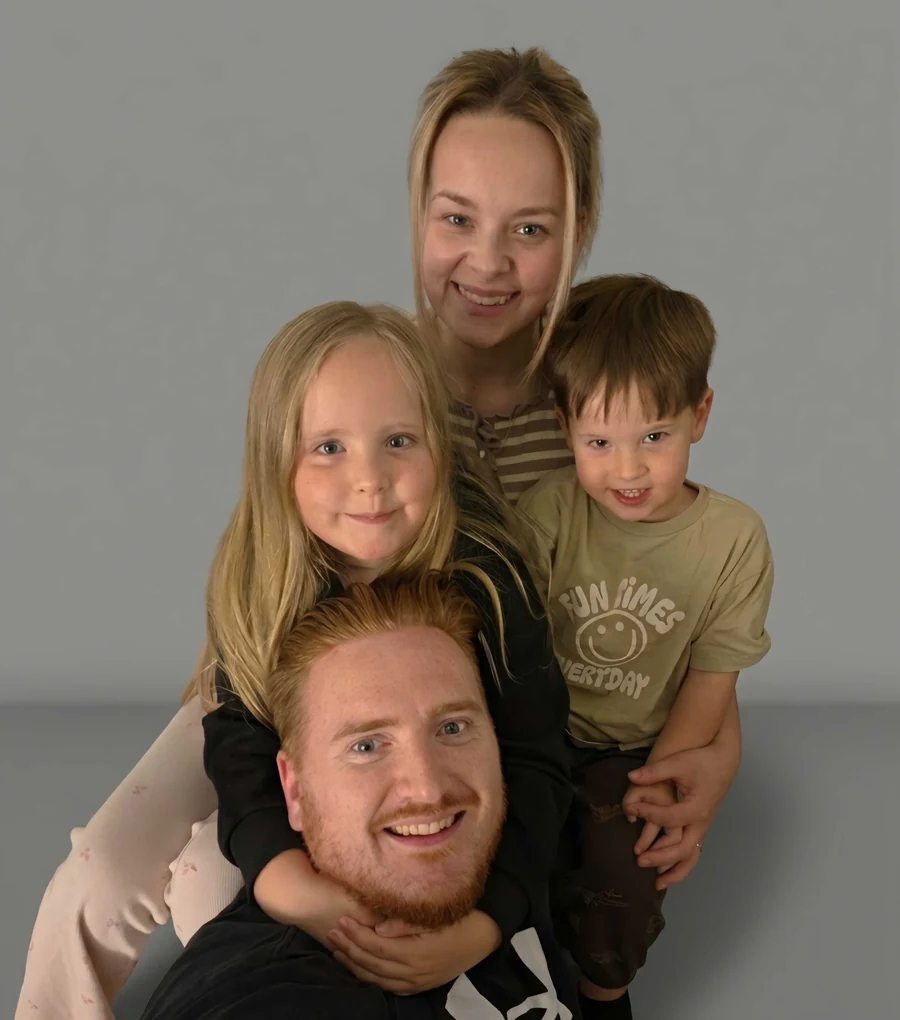 Stuart Martin smiling with his family
